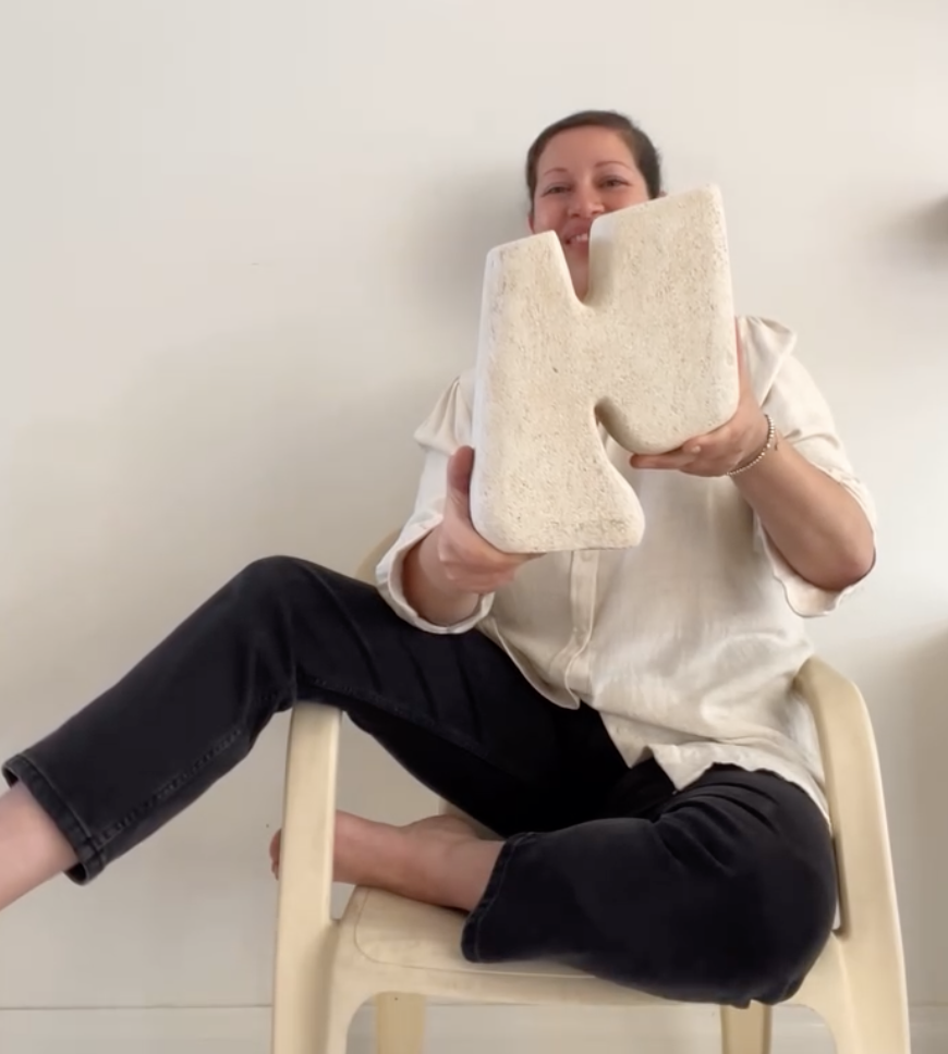 Portrait of Evelyn Michaelides holding a limestone sculpture